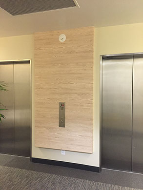 Wood grain architectural film on an elevator lobby