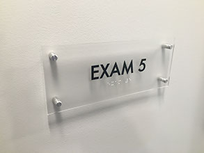 Acrylic room sign mounted with brushed metal stand-offs