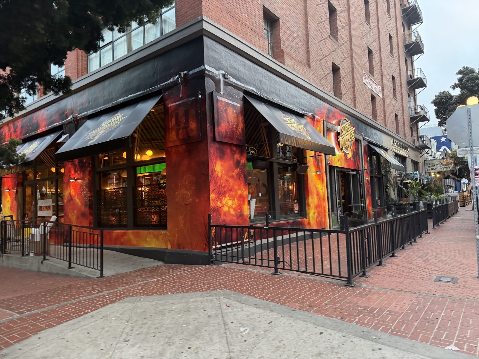 Fire-themed Comic-Con activation building wrap on a Gaslamp Quarter restaurant corner